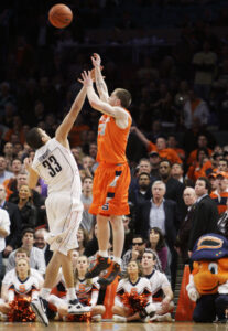 Syracuse's Eric Devendorf, right, puts up a three-point shot over Connecticut's Gavin Edwards at the end of regulation during a quarterfinal NCAA college basketball game at the Big East men's tournament Thursday, March 12, 2009 at Madison Square Garden in New York. The shot, which would have won the game fell through the net, but referees reviewed the play and determined that time had run out before the release forcing the game into overtime. After six overtime periods Syracuse won 127-117. (AP Photo/Julie Jacobson)
