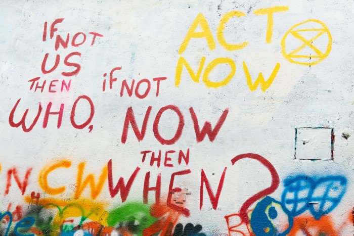 Street art in Prague. Read, "If not us then who, if not now then when? Act Now."